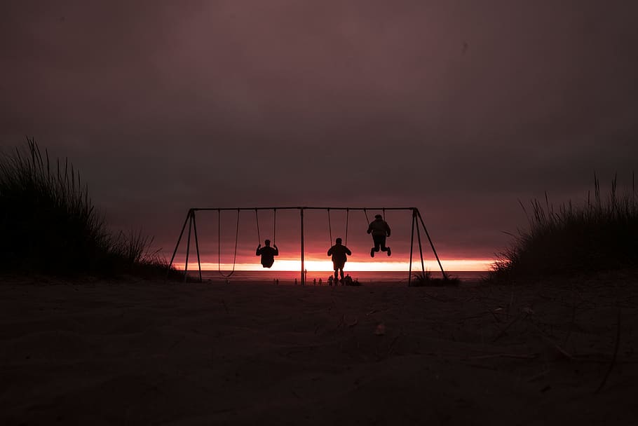 silhouette of three person swinging on outdoor swing, red, orange HD wallpaper