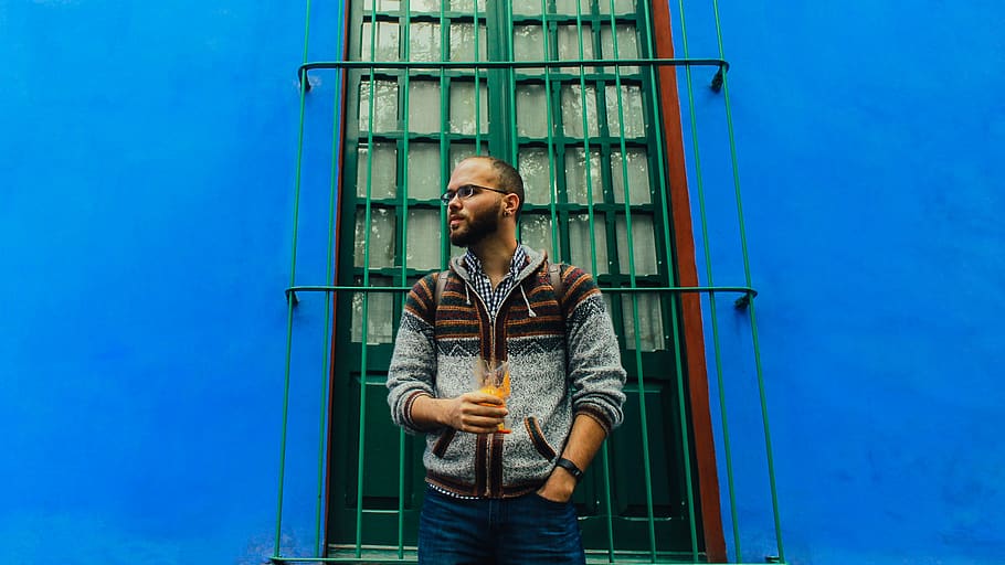 man standing in front of blue wall, human, person, people, mexico