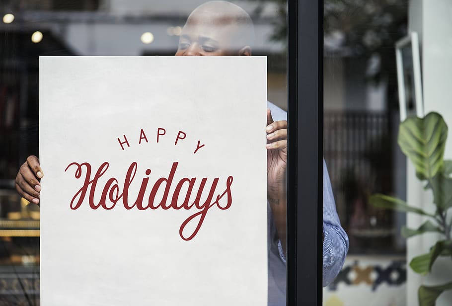 Man Holding Happy Holidays Poster, commerce, glass window, guy HD wallpaper