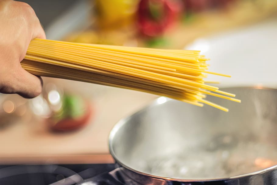 Person Holding Raw Pastas Aiming at Boiling Water in Pot, chef HD wallpaper
