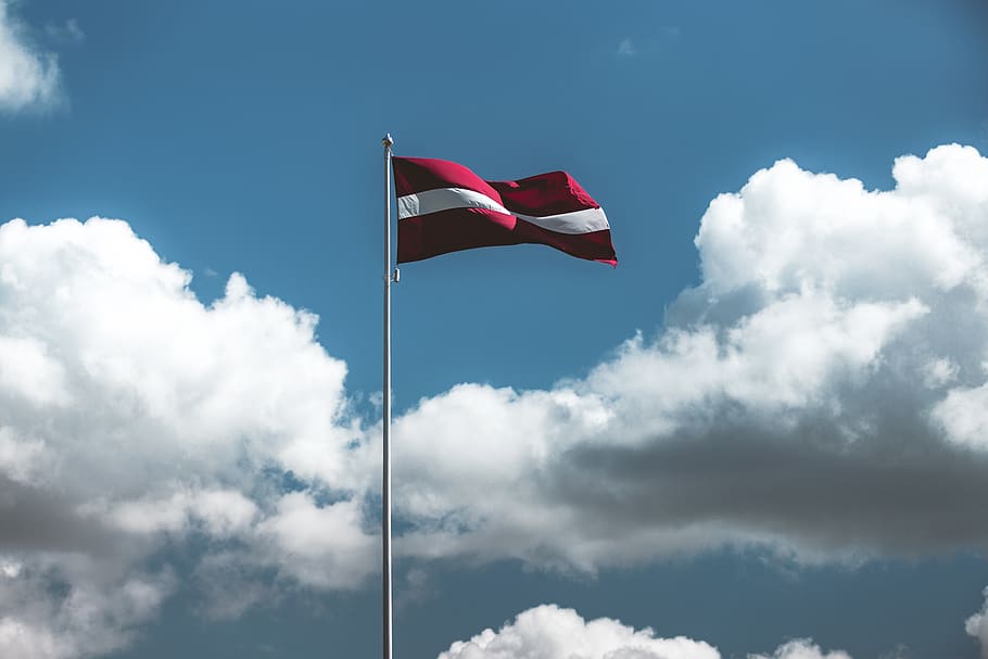 red and white striped flag, symbol, sky, cloud, sunlight, blue