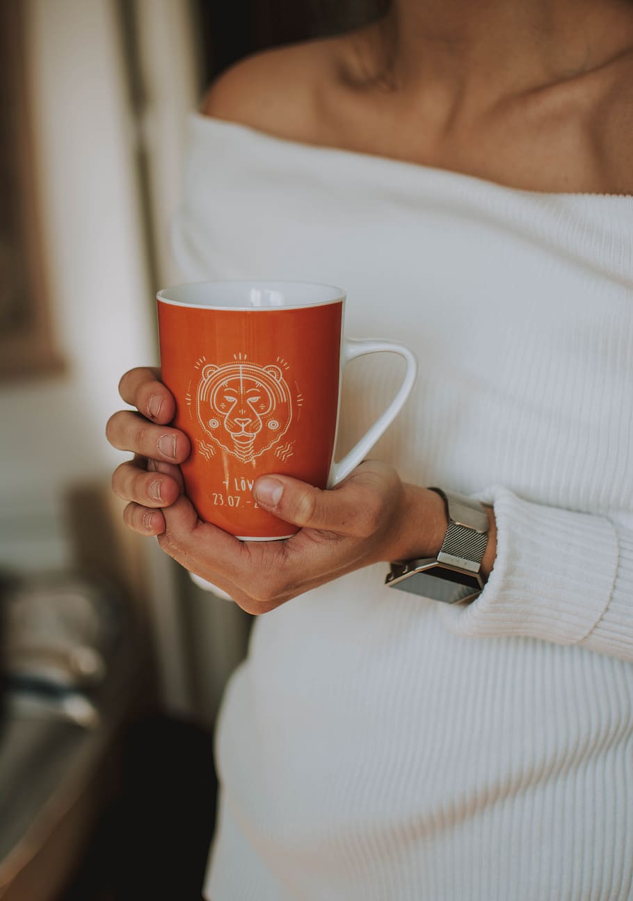 shallow focus photo of orange and white ceramic mug, cup, hand HD wallpaper