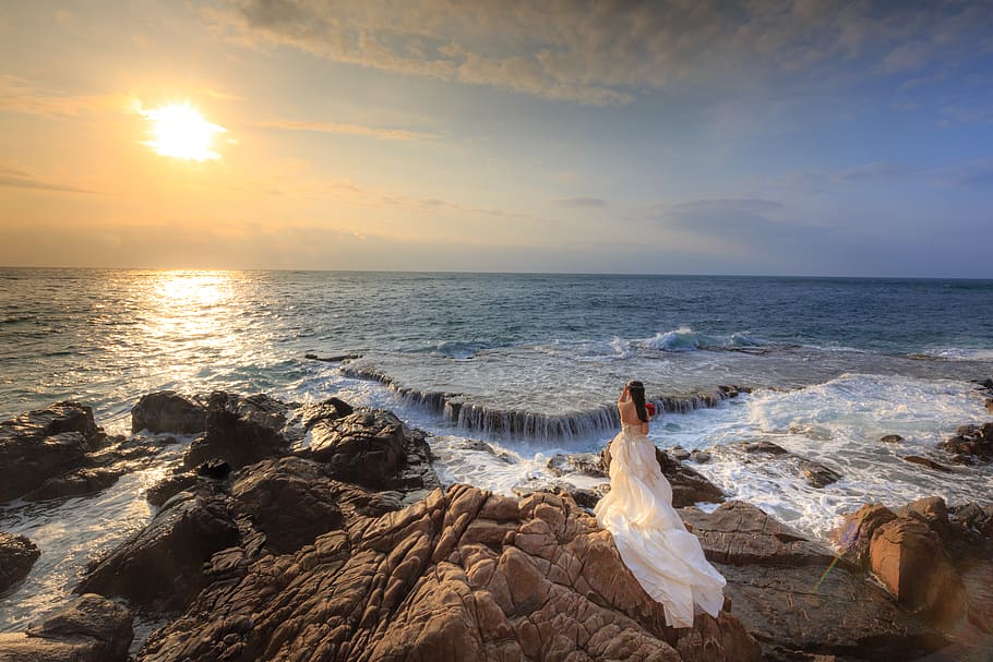Woman Standing on Rock Near Body of Water, beach, clouds, dawn HD wallpaper