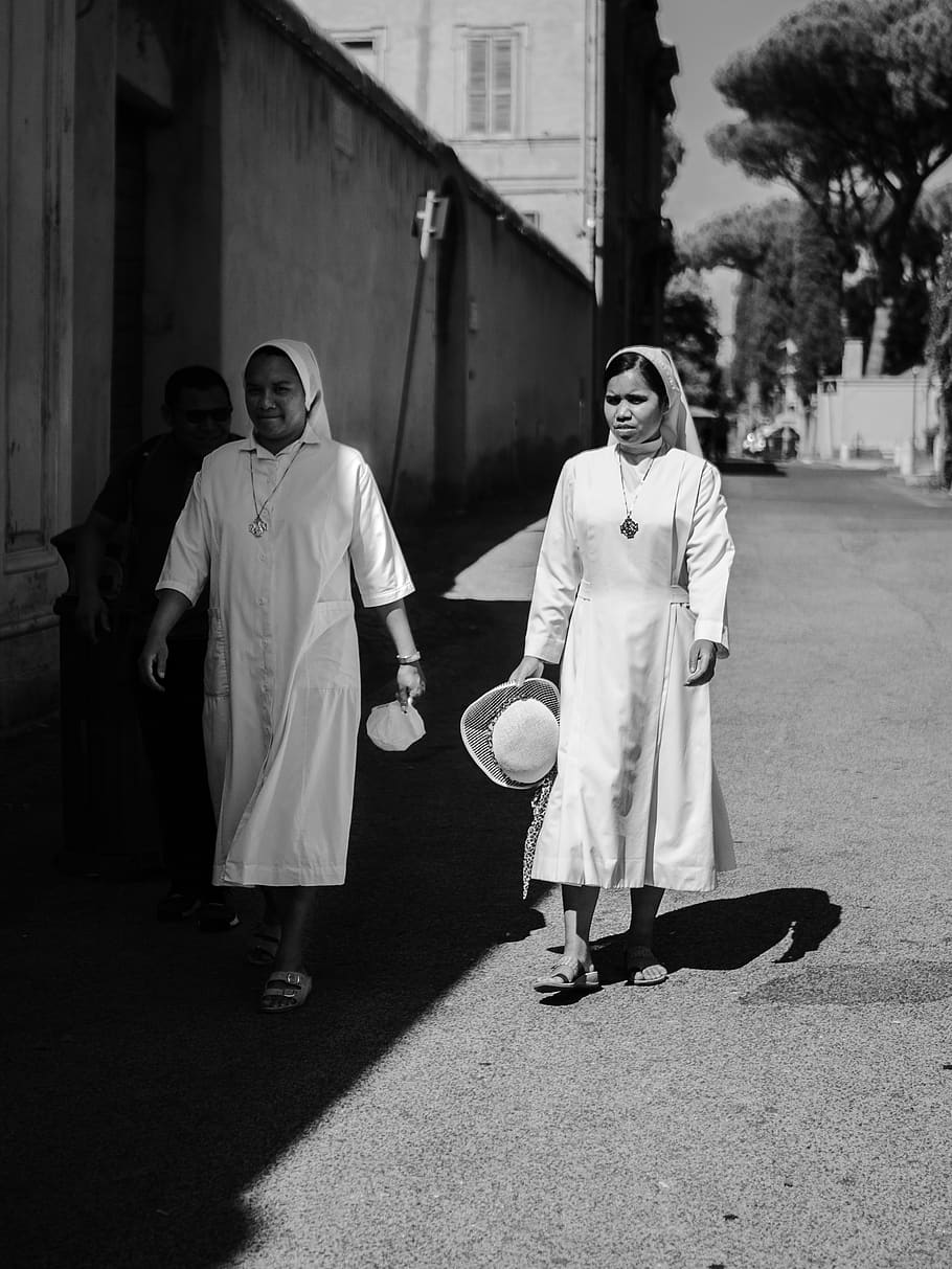 two nun walking beside house, clothing, apparel, human, person