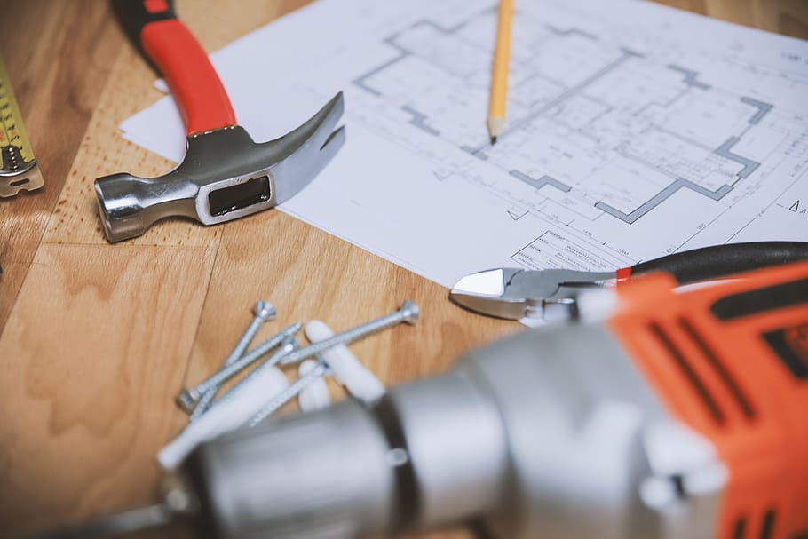 Hammer and other tools with an apartment plan, construction industry