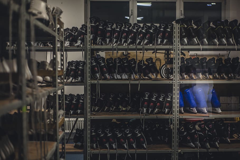 Black and Blue Ice Skates on Gray Metal Shelf Inside White Room HD wallpaper