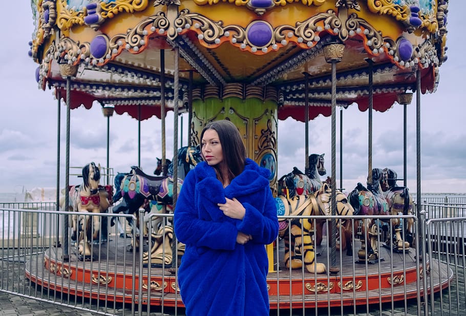 woman-wearing-blue-coat-near-carousel.jpg