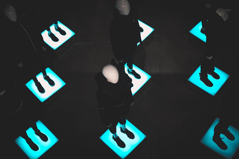 mannequins standing on lighted platforms, illuminated, high angle view