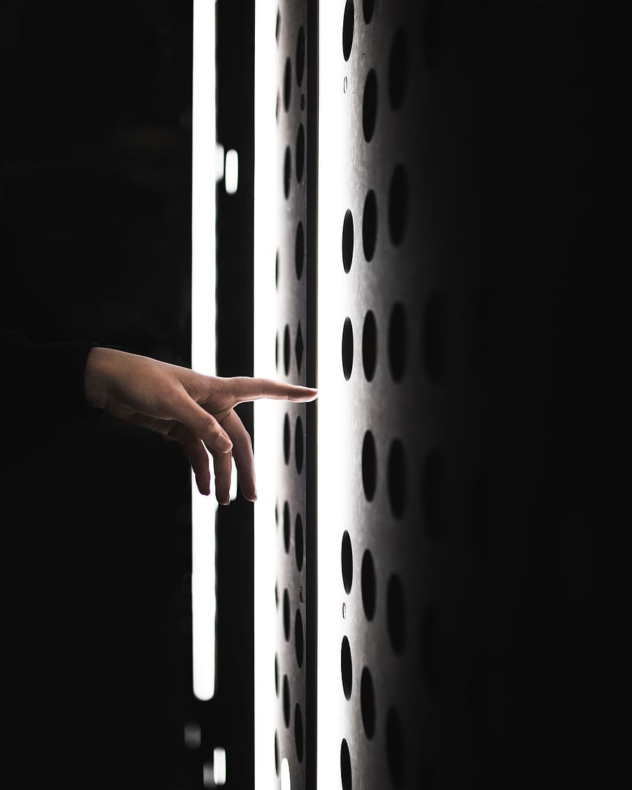 low light photo of left person's hand pointing gray surface, wall HD wallpaper