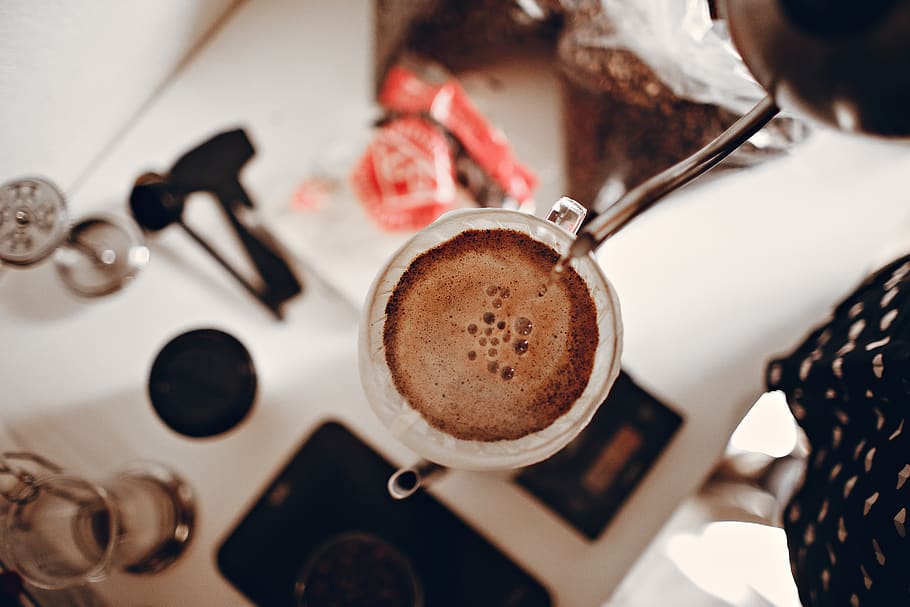 top view photography of person pouring coffee on white ceramic cup, HD wallpaper