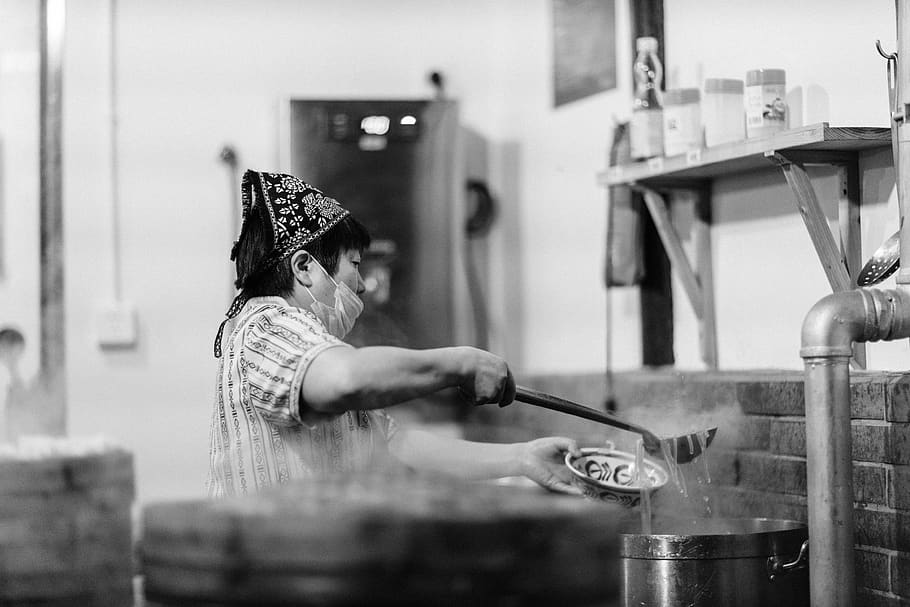 grayscale photography of woman scooping noodles, person, human