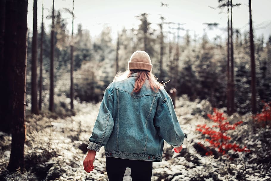 Woman Wearing Blue Denim Jacket and White Beanie Walking in the Forest HD wallpaper