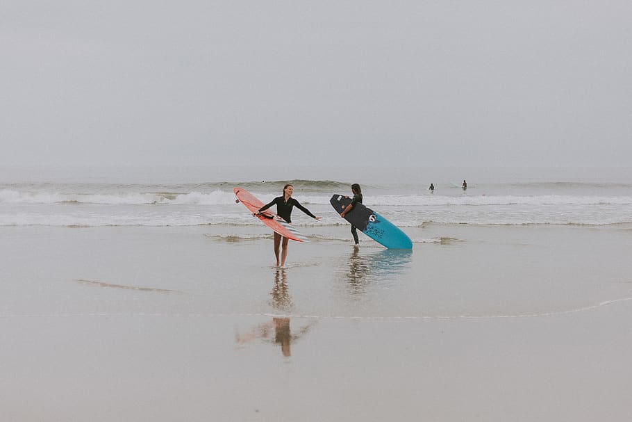 Photography of People On Seashore Holding Surboard, activity HD wallpaper