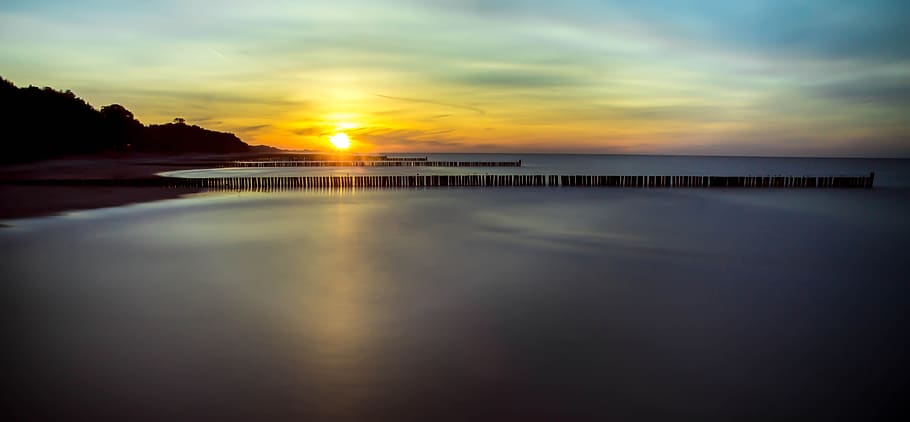Landscape Photography of Calm Body of Water Under Cloudy Sky HD wallpaper