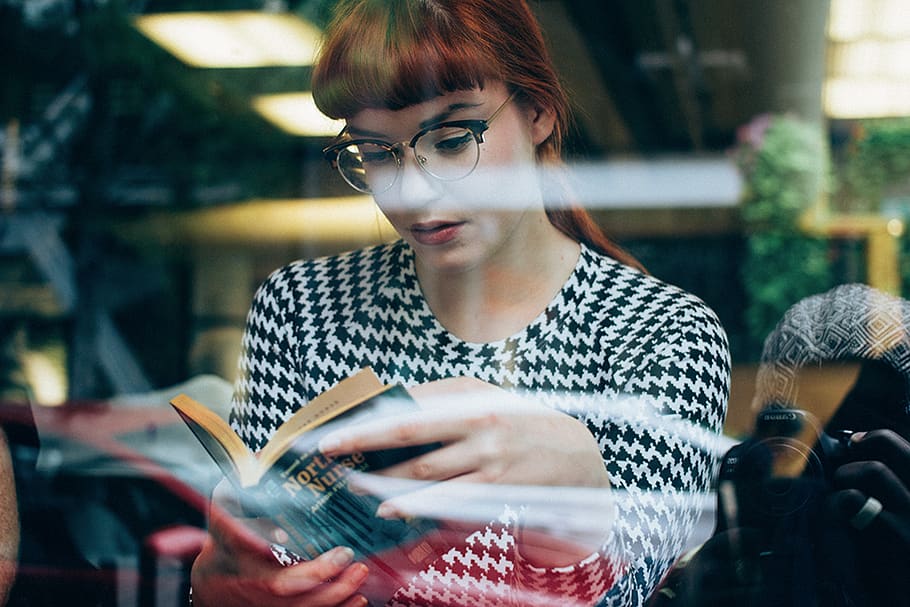 Woman Wearing Eyeglasses Reading Book, female, glass wall, hands