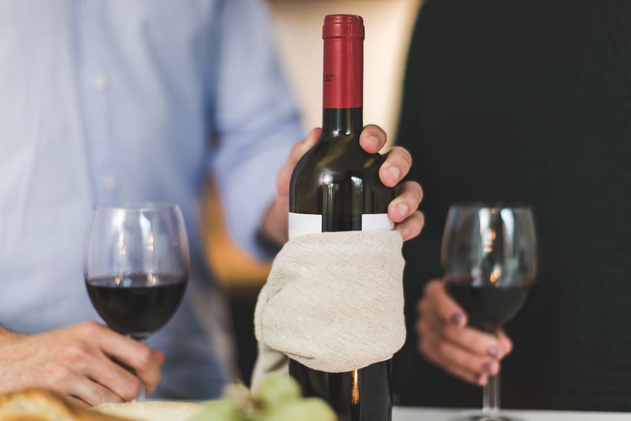 Man Holding White Labeled Red Wine Bottle Near Wine Glasses, alcohol HD wallpaper