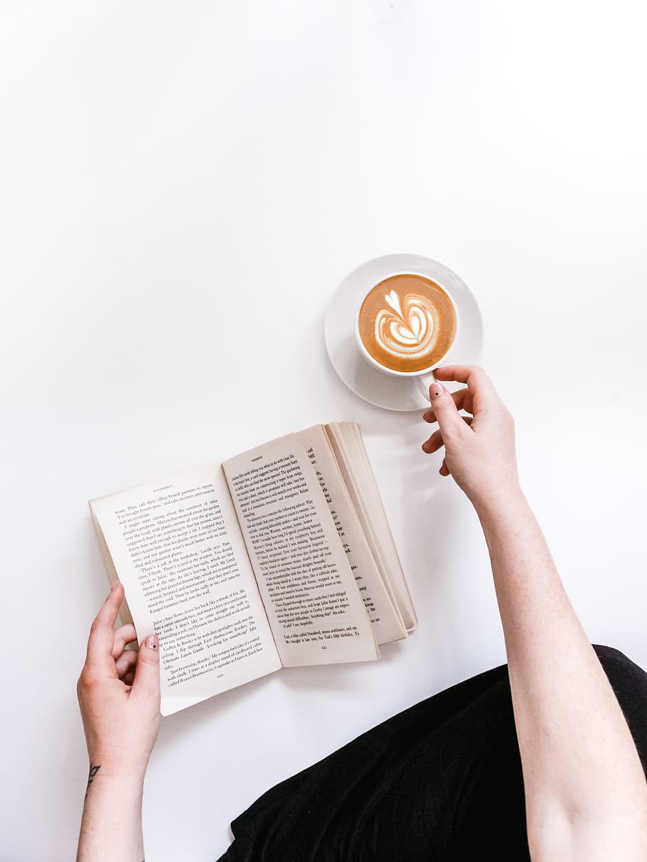 opened book and coffee on white surface, holding, one person HD wallpaper