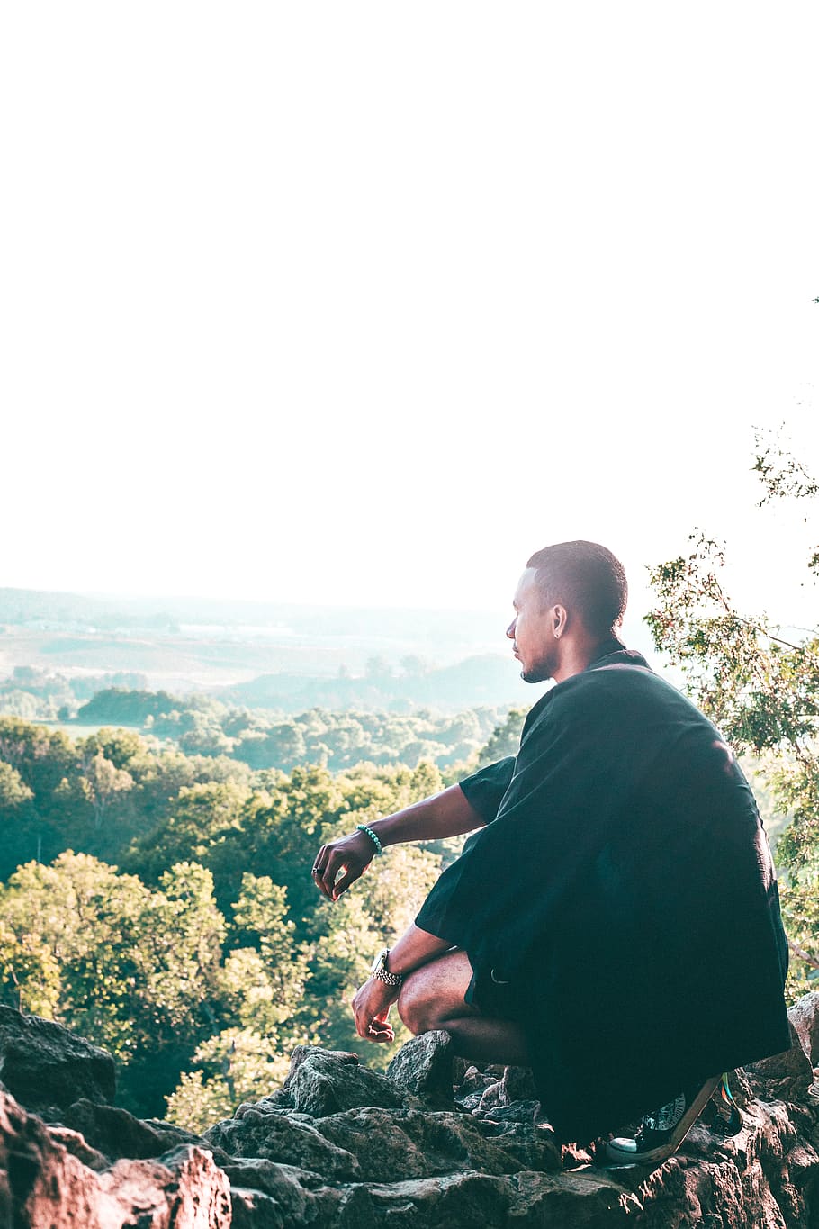 Man Sitting On Cliff Overlooking Trees, adventure, daylight, digital nomad, HD wallpaper