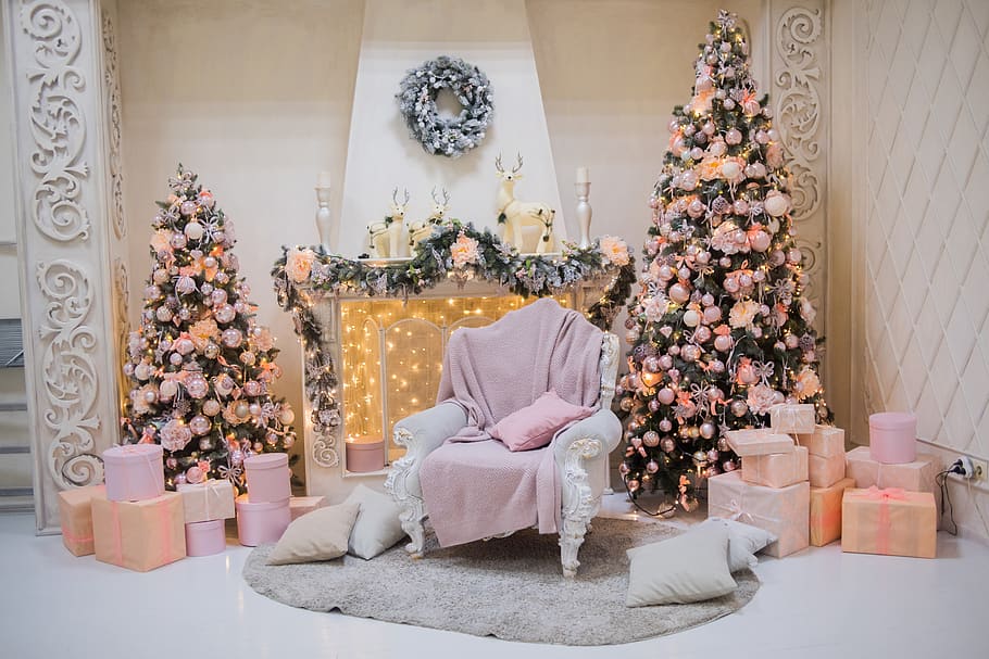 pillows beside sofa chairs in front of Christmas tree, plant