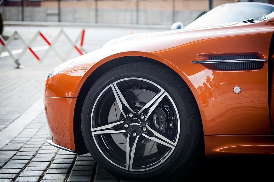 Orange Car Parked Near Grey Triangular Sign during Daytime, aston martin, HD wallpaper