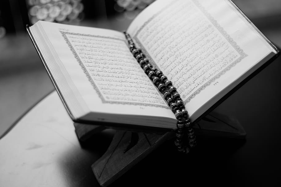 Grayscale Photo of Opened Qur'an, beads, black-and-white, close-up