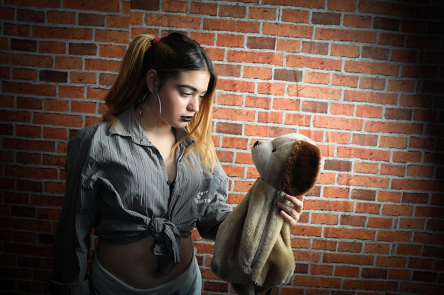 Woman Looking and Holding Brown Dog Plush Toy, beautiful, brickwall, HD wallpaper