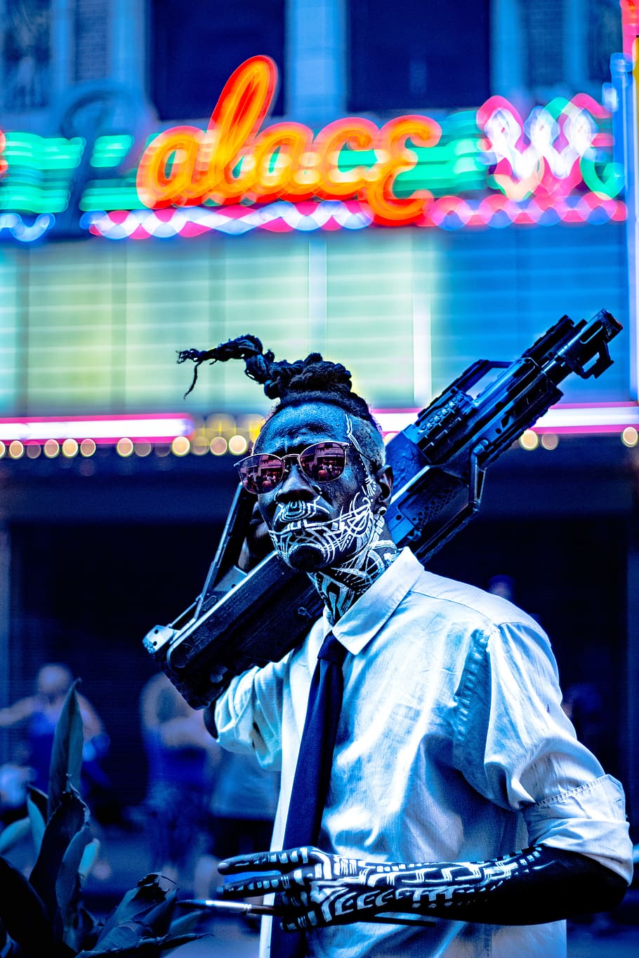 man with tattoo carrying rifle, futuristic, body paint, gun, dreadlock HD wallpaper