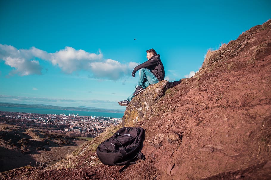 man sitting on mountain cliff, rock, rock - object, solid, one person HD wallpaper