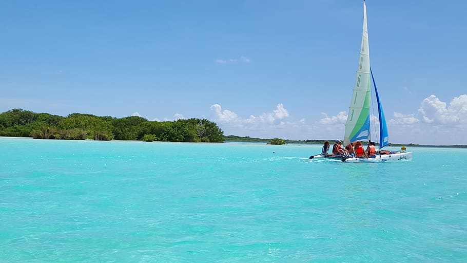 Group of People Riding Sailboat on Body of Water, beach, clouds HD wallpaper