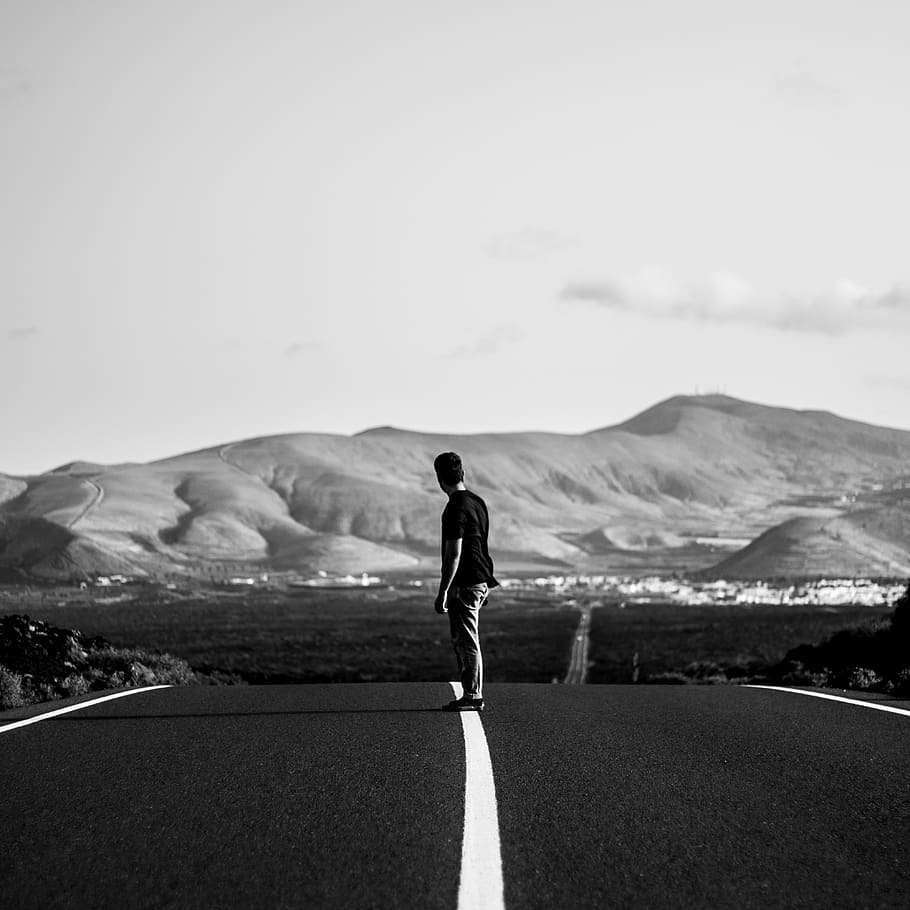 grayscale photography of man standing in the middle of road, person, HD wallpaper