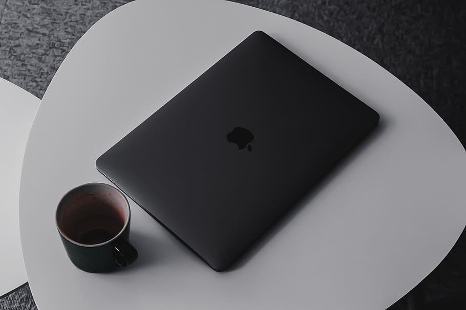 MacBook Pro beside mug on table, high angle view, still life HD wallpaper