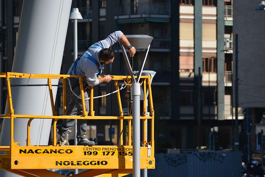 man fixing gray tower, person, human, milan, italy, construction HD wallpaper