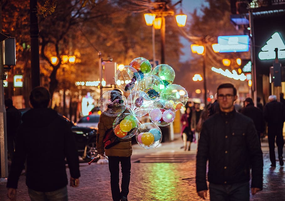 person holding balloons, city, street, night, celebration, illuminated HD wallpaper
