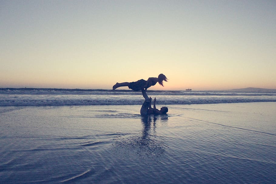 Landscape Photography of Man Lifting Woman by His Foot on Seashore HD wallpaper