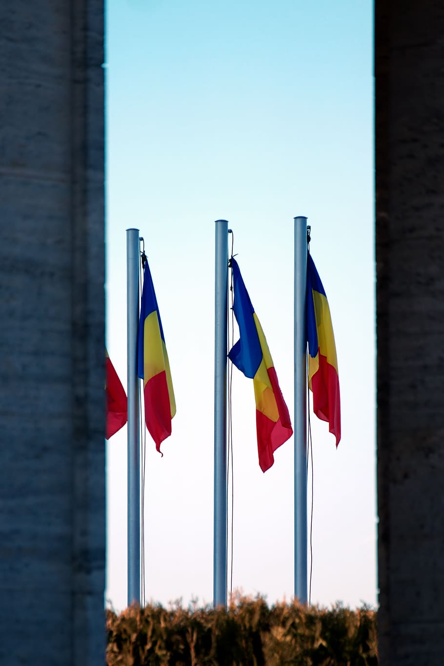Three Blue-yellow-and-red Flags on Gray Pole, city, colors, light HD wallpaper