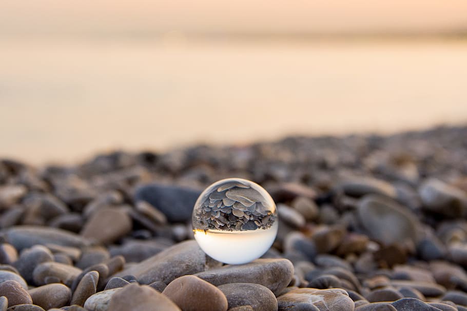 HD wallpaper: marble toy on stone, ball, glass sphere, beach, ocean, sea,  bokeh | Wallpaper Flare