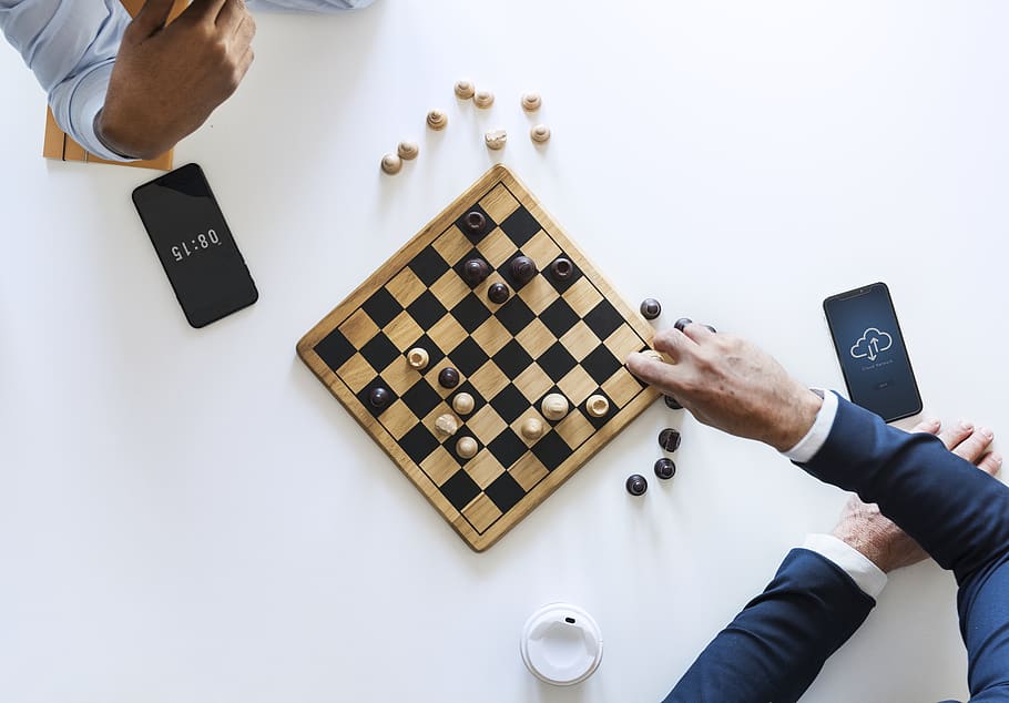 Flat Lay Photography of Two Men Playing Chess, aerial, chess pieces
