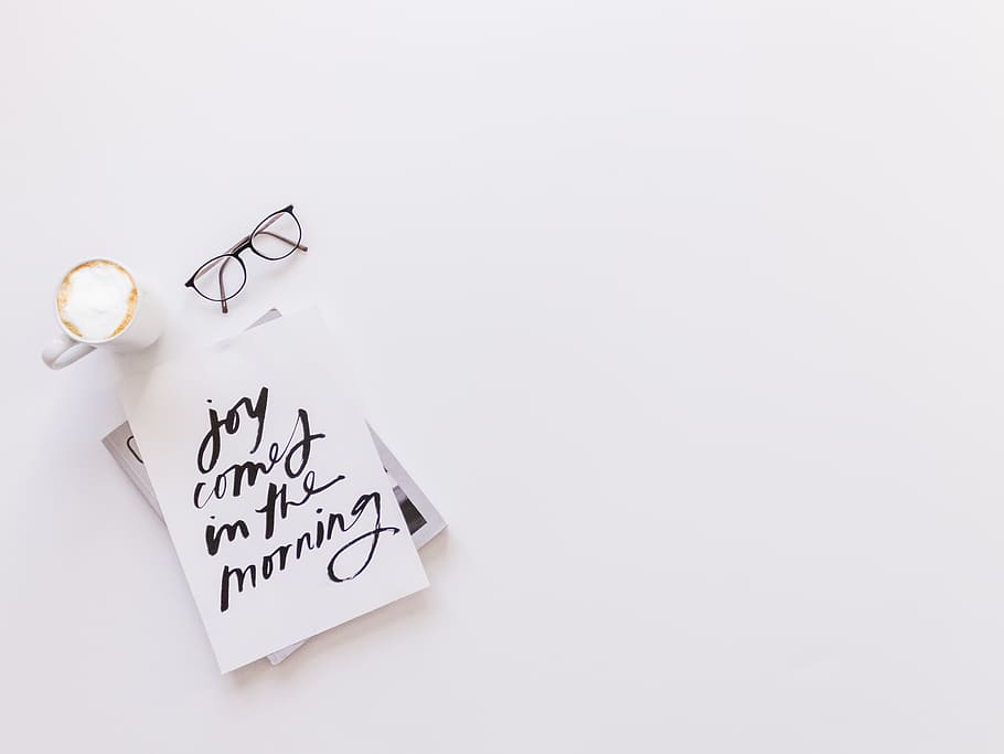 joy comes in the morning card beside coffee and eyeglasses, text
