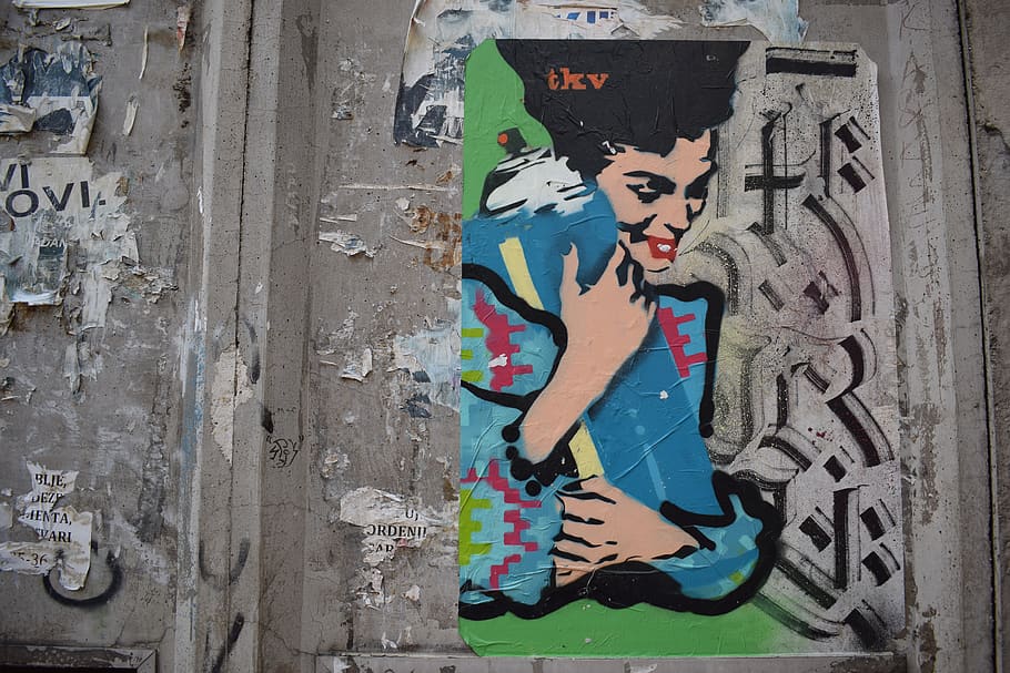 woman holding blue textile painting, graffiti, belgrade, serbia
