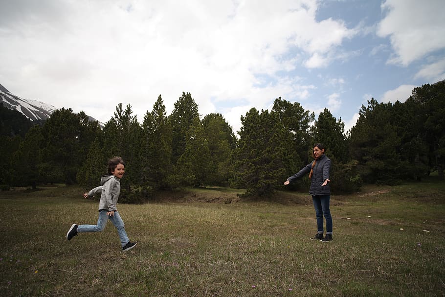 Woman and Boy Standing on Pasture, child, clouds, daylight, daytime HD wallpaper