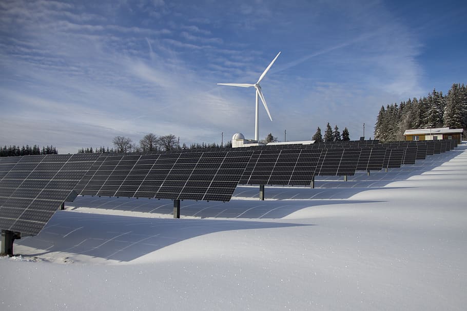 Solar Panels on Snow With Windmill Under Clear Day Sky, alternative