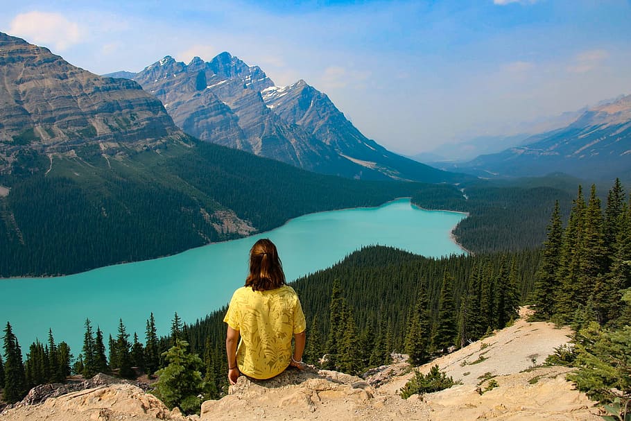 Person Sitting on Rocky Mountain Near Body of Water, adventure HD wallpaper