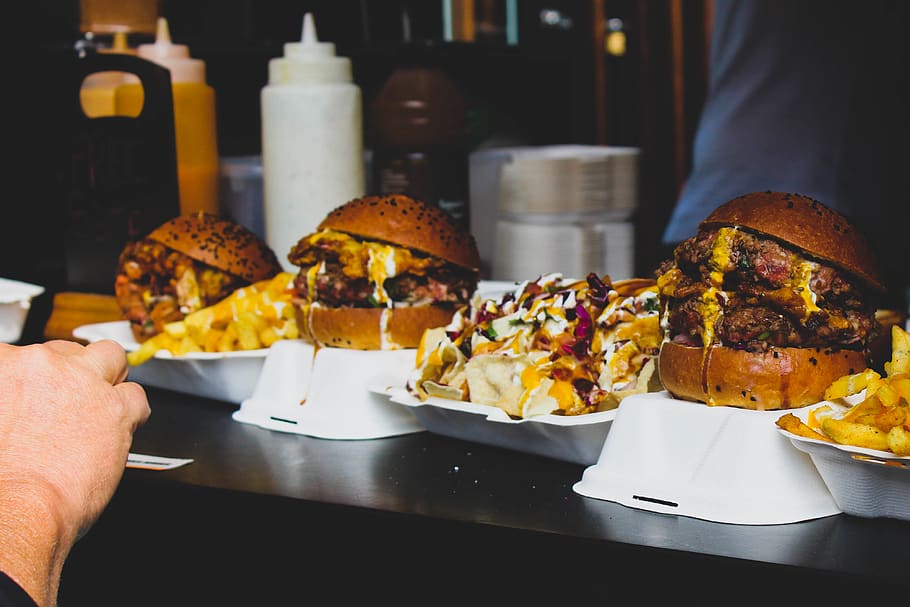 three cooked burger sandwhiches, human hand, food and drink, human body part HD wallpaper