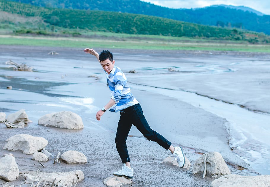 Man Standing on Rock Near Body of Water, balance, daytime, field HD wallpaper