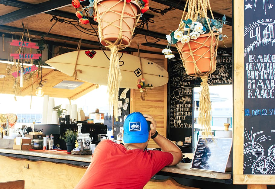 Man Near Counter Desk With Hanging Surfboard, business, café HD wallpaper