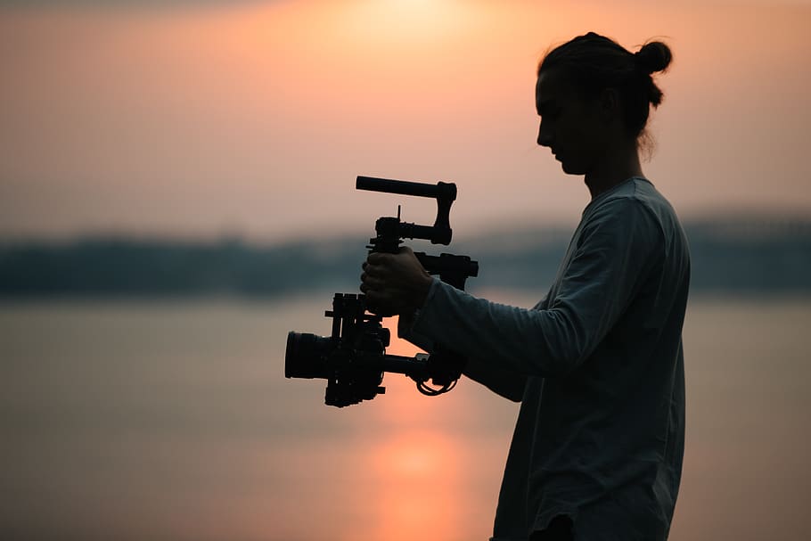 man holding camera, human, person, photography, weapon, gun, weaponry HD wallpaper