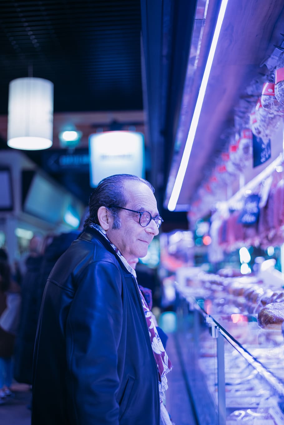 man looking at items, person, human, lighting, market, glasses HD wallpaper