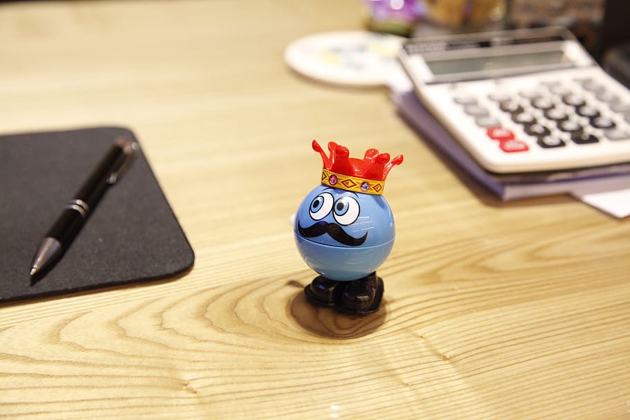 Blue Round Plastic Toy on a desk, blur, calculator, composition