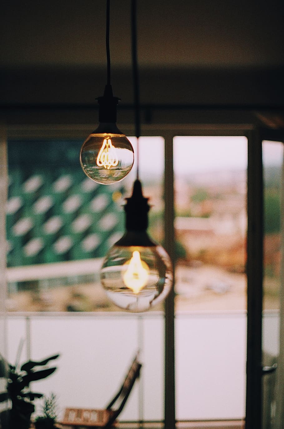 two light bulbs, lighting equipment, illuminated, hanging, focus on foreground HD wallpaper