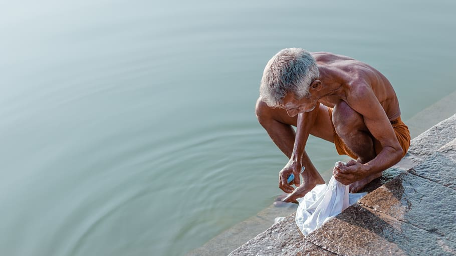 man holding textile, water, one person, real people, shirtless HD wallpaper